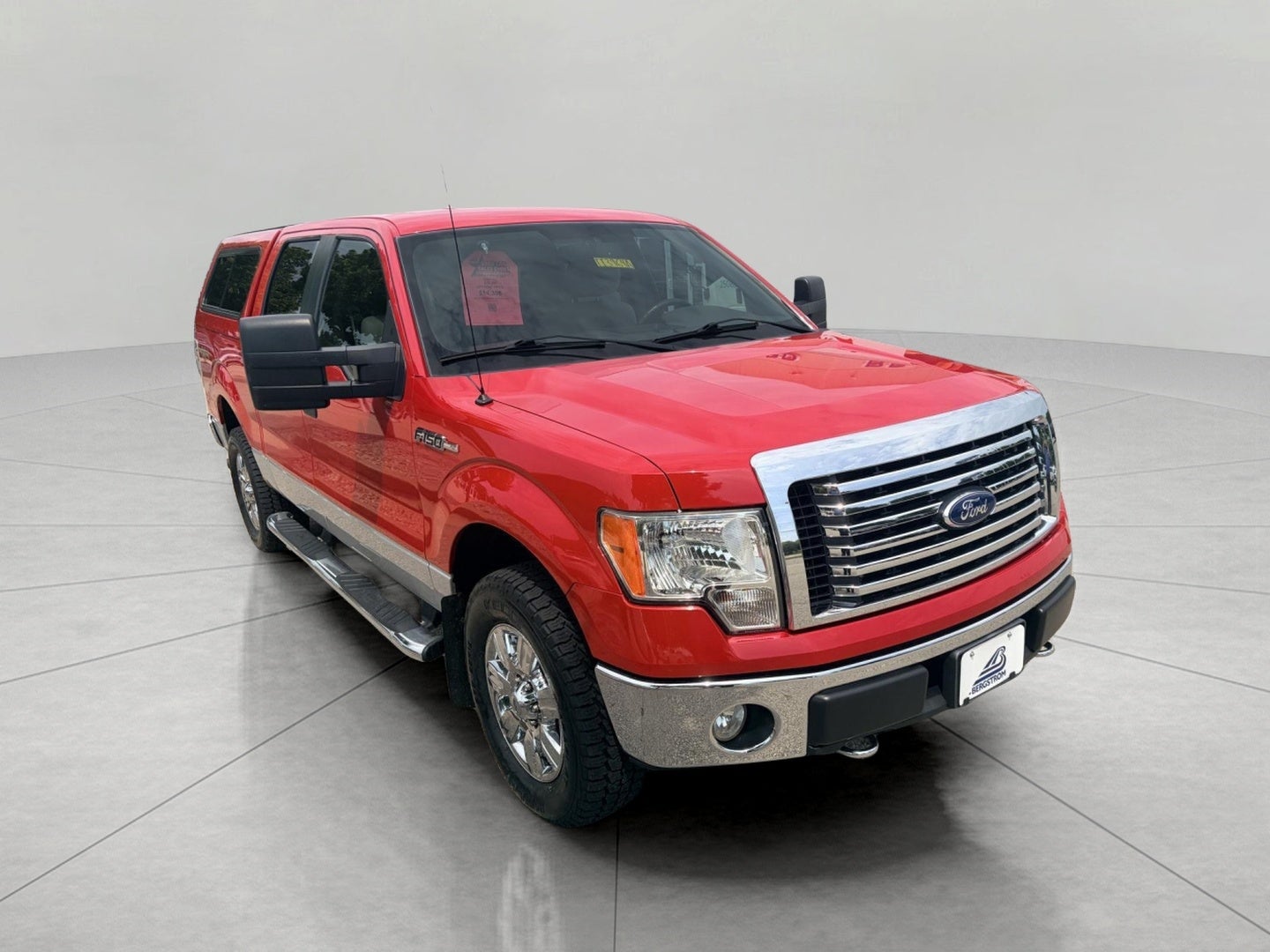 2010 Ford F-150 4WD SuperCrew 145 XLT in Vermillion Red — front three-quarter view